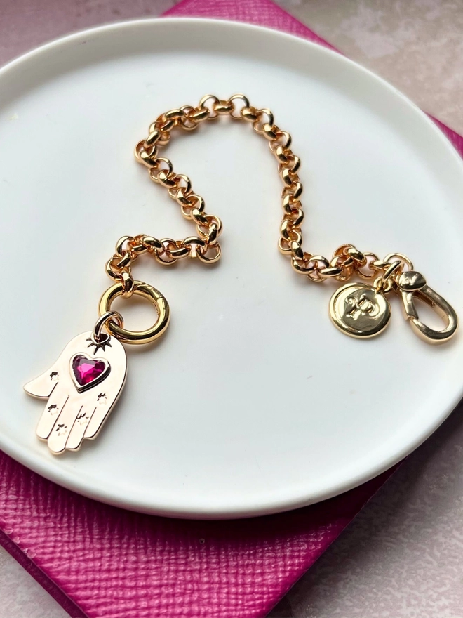 Gold belcher chain bracelet with gold and pink quartz hamsa hand charm