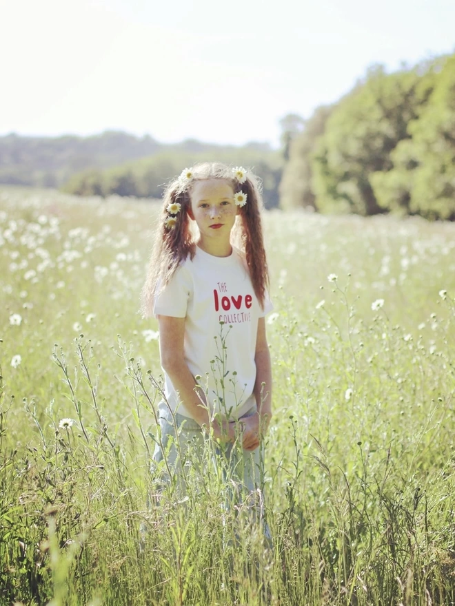 girl in field with The Love Collective screen printed tshirt