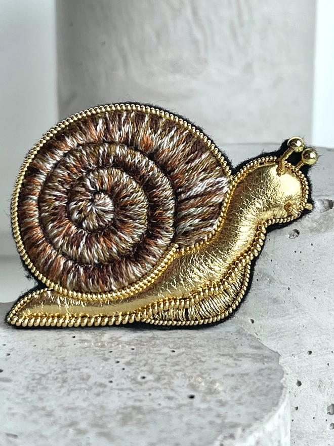 golden snail brooch
