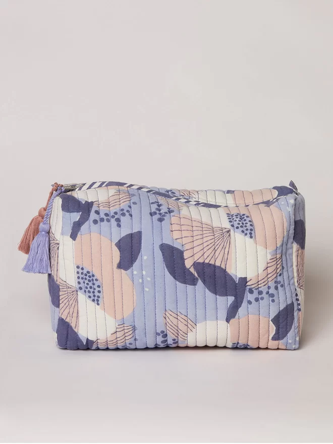Block printed blue washbag in a large scale floral in cream, pink and navy shades