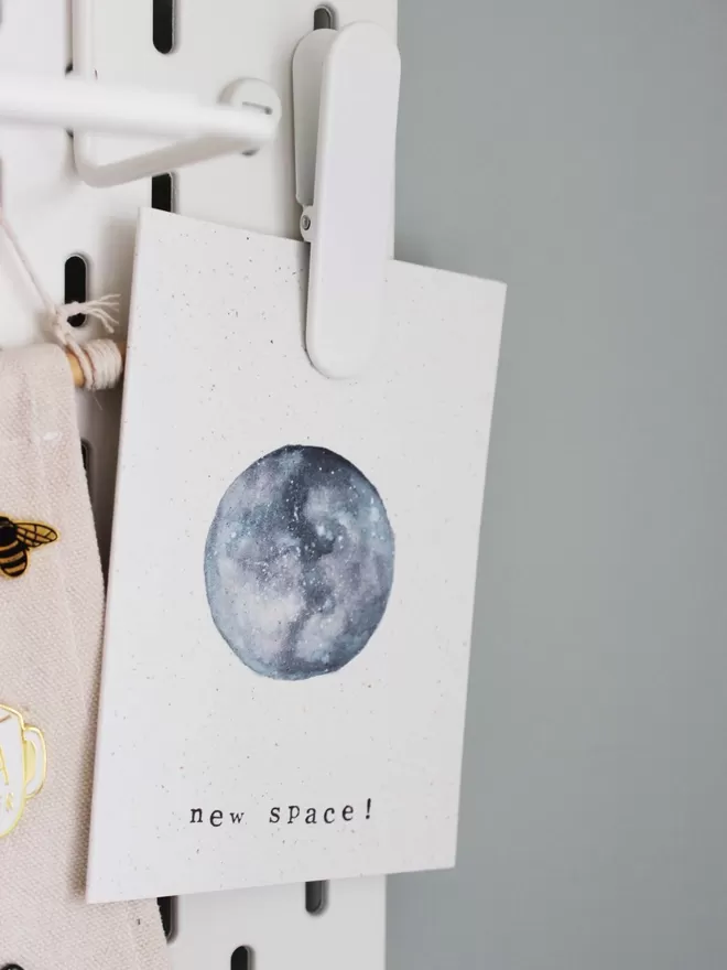 'New Space' Card pinned on peg board