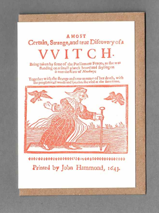 White card with orange illustration of a witch and text reading 'A Most Certain, Strange and true Discovery of a Witch' with a brown envelope behind