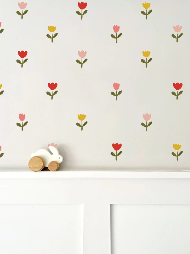 Kids Spring Tulip Wall Stickers on off white wall with white wall panelling below and wooden bunny rabbit toy