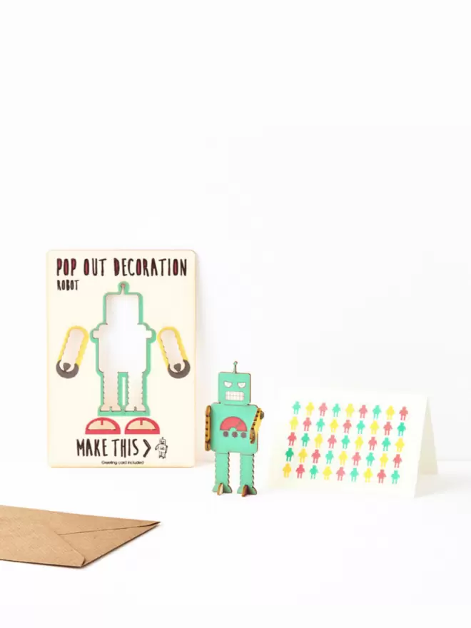 Green robot decoration and robot pattern greeting card and brown kraft envelope on a white background