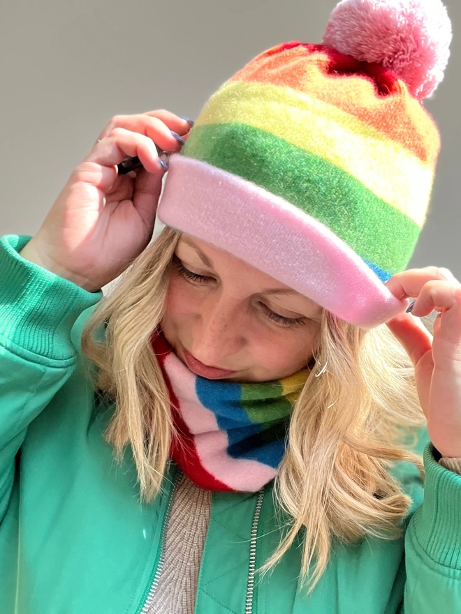 Rainbow striped knitted beanie hat worn with matching snood