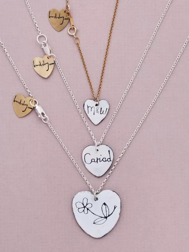 Buddug personalised necklaces seen in different heart shaped.