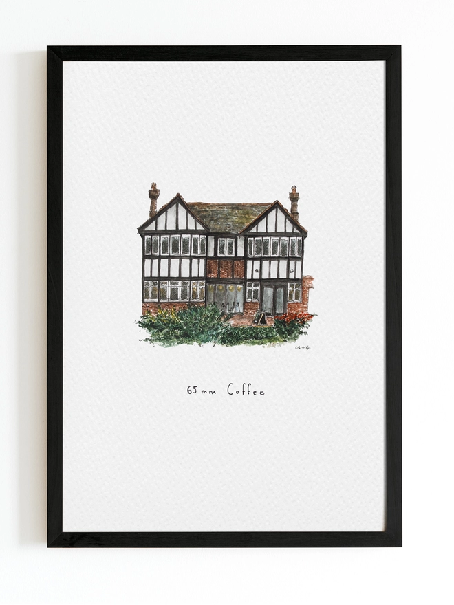 Beautiful watercolour illustration of 65mm Coffee, independent cafe and coffee shop in Tonbridge.  A characterful black and white tudor style two storey building with small diamond paned windows on the ground floor and brick below. There is dark green foliage and bushes infront of the building. The watercolour style is painted with a black pen outline and organic loose style with small details. The print is on white background with black frame around.