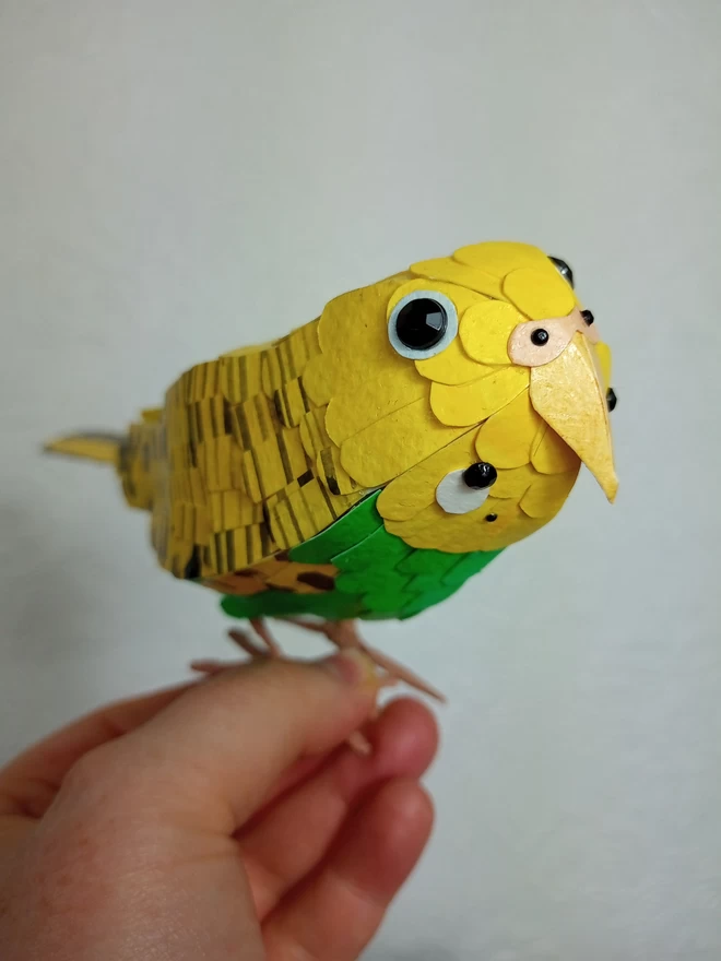 yellow budgie sculpture, made from hand printed papers