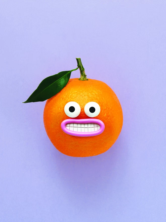 An Orange with a very smiley face, with a leaf, on a purple background