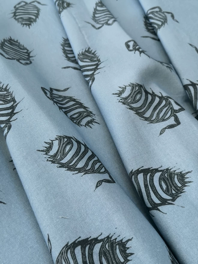 Cotton linen light blue fabric with a charcoal woodlouse print.