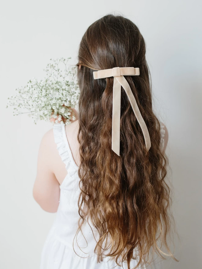 girl with velvet hair bow in cream