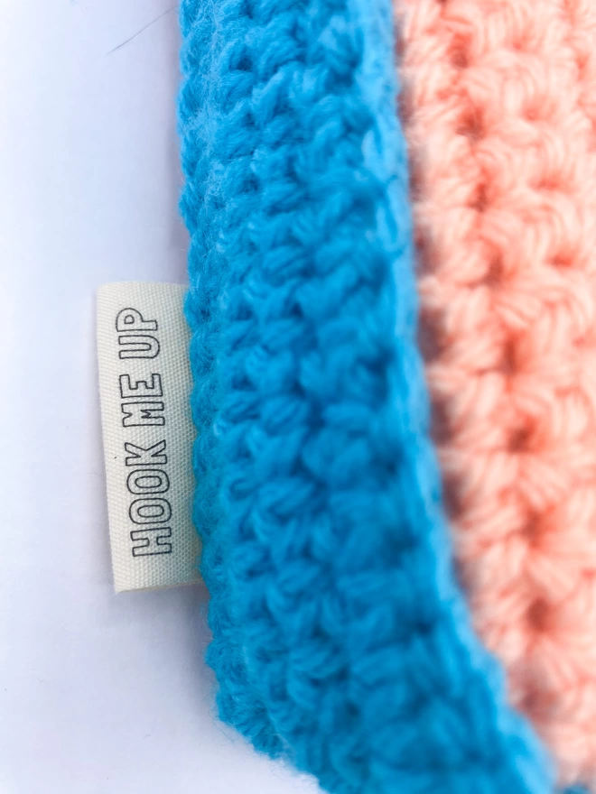 Close up of Crocheted F Cushion in Peachy Pink & Light Blue