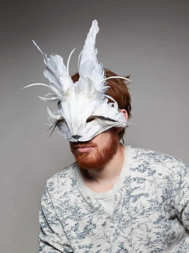 Man wearing luxury white rabbit masquerade mask over his face