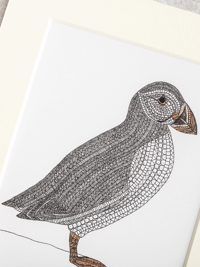 Print of an intricately patterned pen and watercolour drawing of a Puffin bird, in a soft white mount
