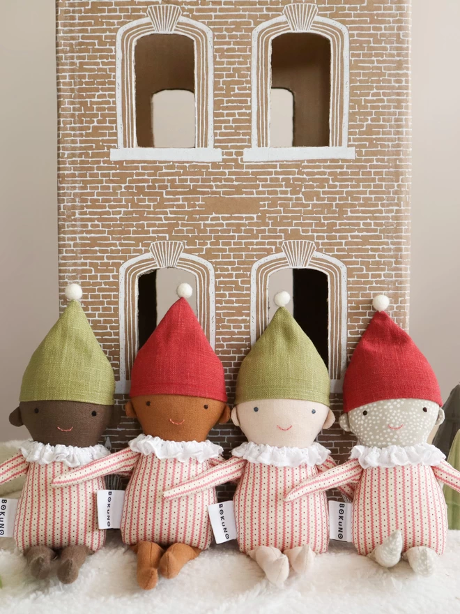 handmade elf dolls in stripe top and red or green hat dark mixed light skin tones and freckles 