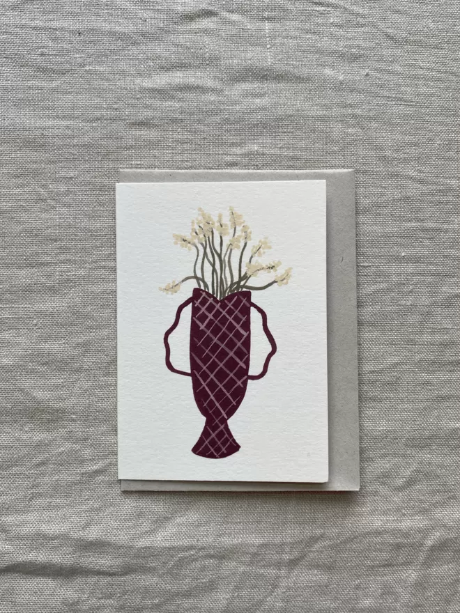 a greetings card with cut wildflower flowers in a vase