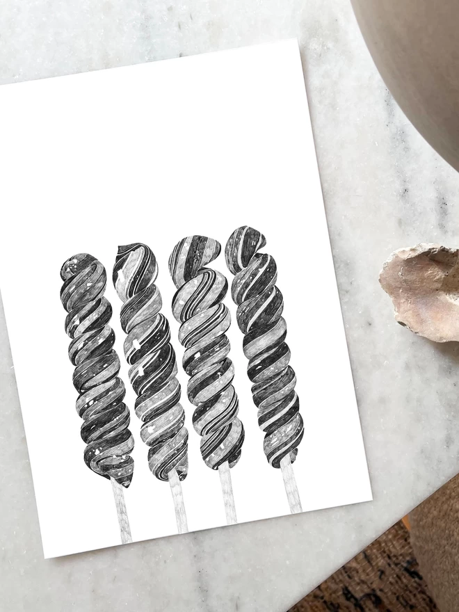 Art print of hand drawn illustrations of rock lollies laying on a table
