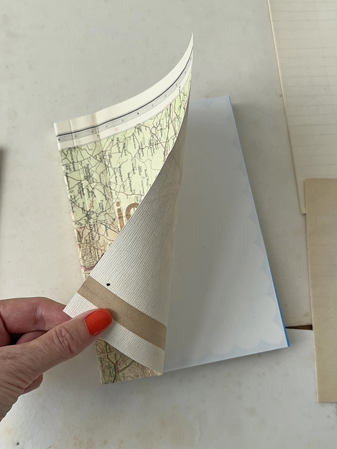 opening the linen map journal showing the inside cover