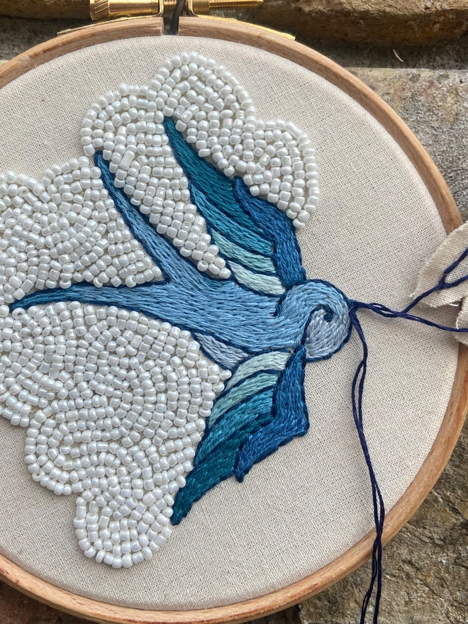Embroidery blue swallow with white beaded cloud