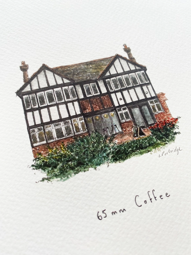  Beautiful watercolour illustration of 65mm Coffee, independent cafe and coffee shop in Tonbridge.  A characterful black and white tudor style two storey building with small diamond paned windows on the ground floor and brick below. There is dark green foliage and bushes infront of the building. The watercolour style is painted with a black pen outline and organic loose style with small details. A photo taken at an angle showing some of the detail. 
