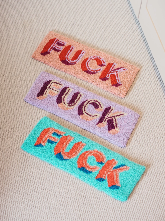 'FUCK' Handmade Tufted Rug/Wall Hanging seen in three colours.