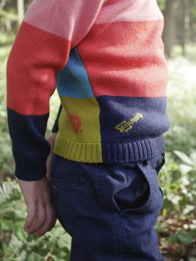 A close up of the details on a 'The Stargazer' Knitted Jumper by The Faraway Gang worn by a little boy.  
