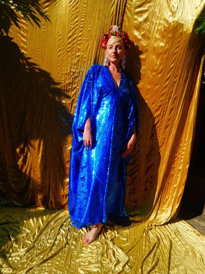 Fumbalina Royal Blue Holographic Sequin V-neck Kaftan Gown seen with her arms by her side.
