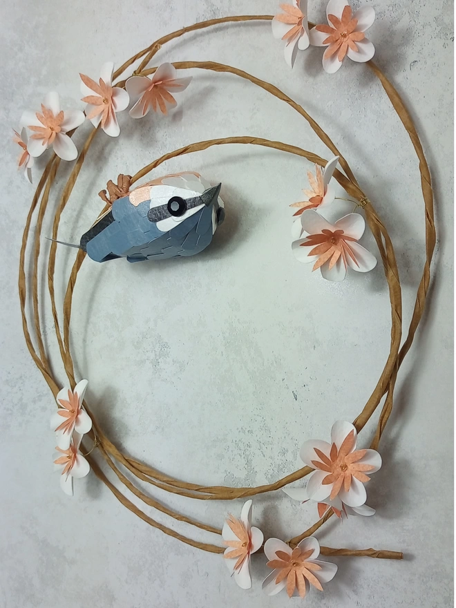 nuthatch paper bird sculpture on a wreath of blossom flowers