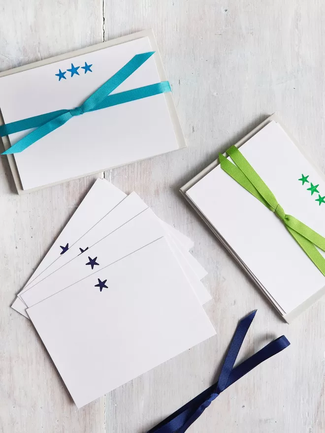 South London Letterpress, Neon Star Notecards seen in green and blue with matching ribbons..