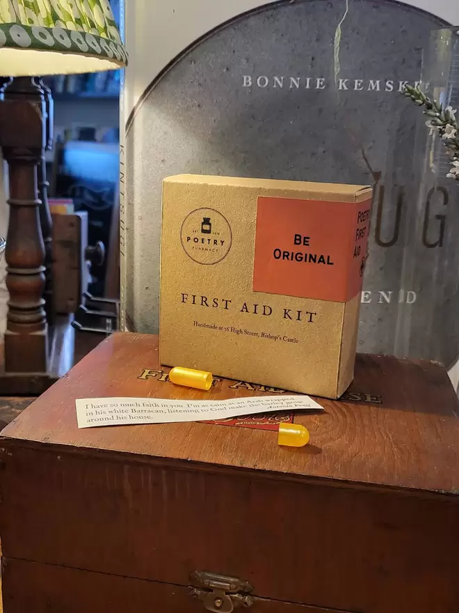 Cardboard box First Aid Kit on a vintage wooden first aid kit