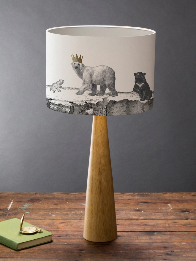 Drum Lampshade featuring bears on a wooden base on a shelf with books and ornaments