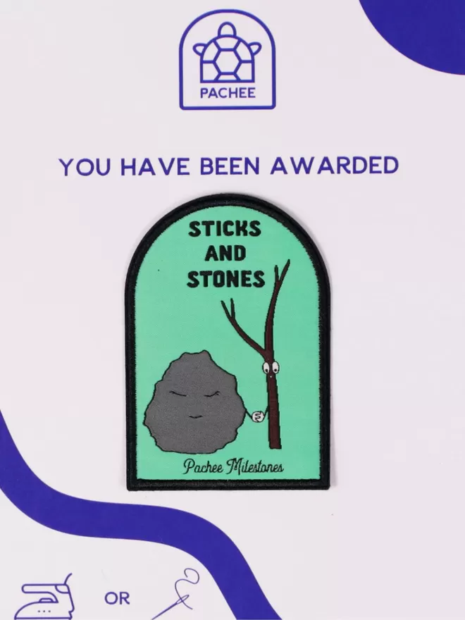 Green patch with a black border depicting a tree and a stone holding hands. 'Sticks and stones' is written above. The patch is seen on the white and blue Pachee gift card. 