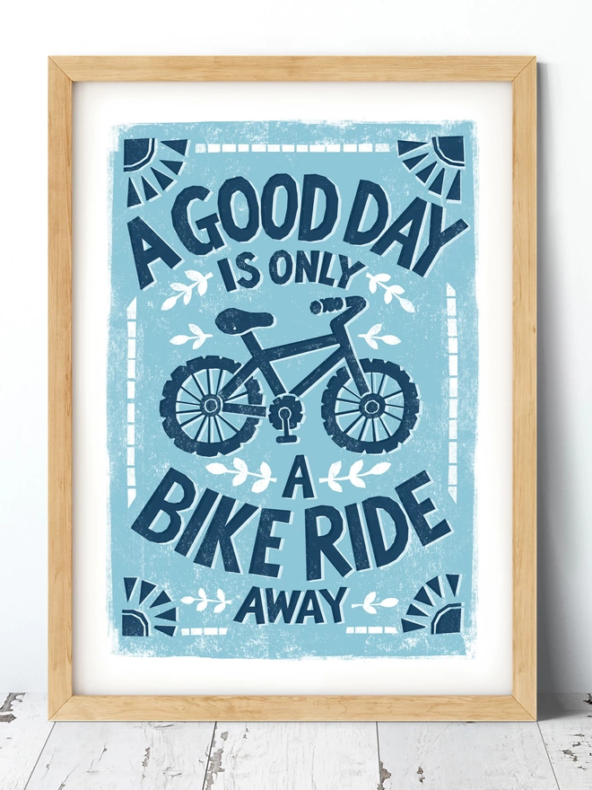 blue cyclists bike ride print in wood frame