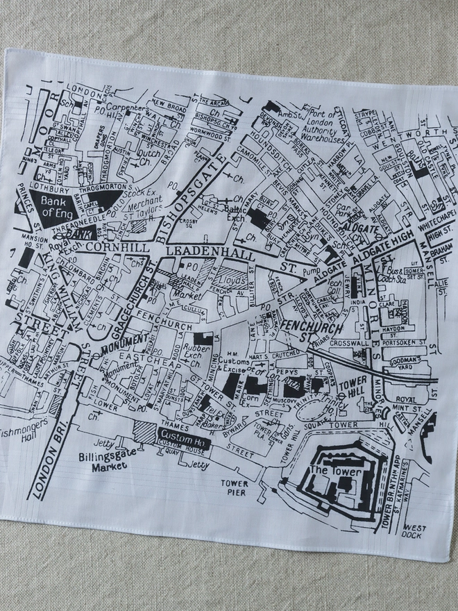 Mr.PS London City map hankie printed in charcoal grey laid flat on a plain linen tablecloth