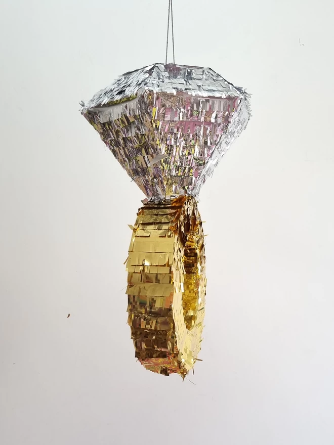 side view of gold and silver diamond ring pinata