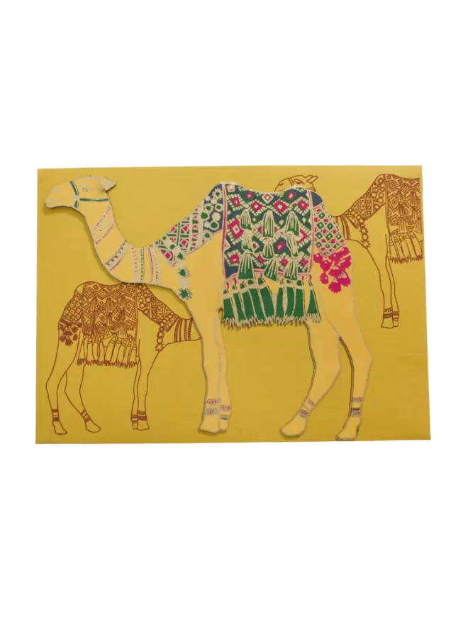 White cut-out shot: yellow camel with green blanket, matching yellow envelope with camel motif