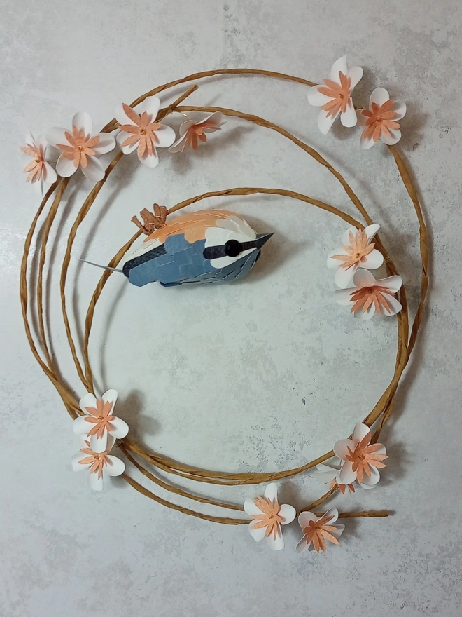 nuthatch sculpture on a blossom wreath