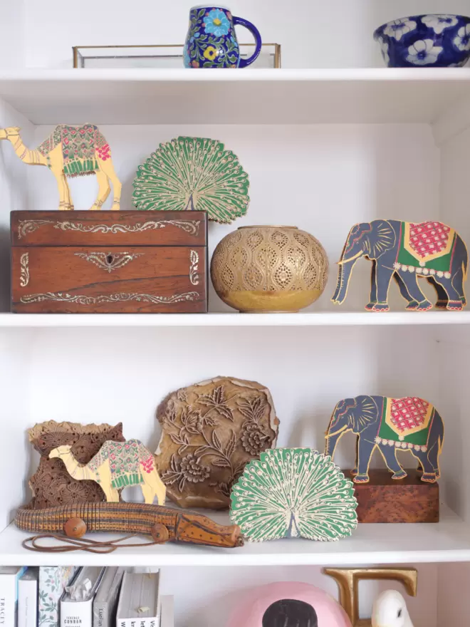 Full shot of image of the 3 Indian animals displayed on shelves