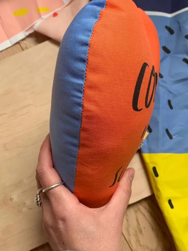 Courage heart plushie seen in orange and blue