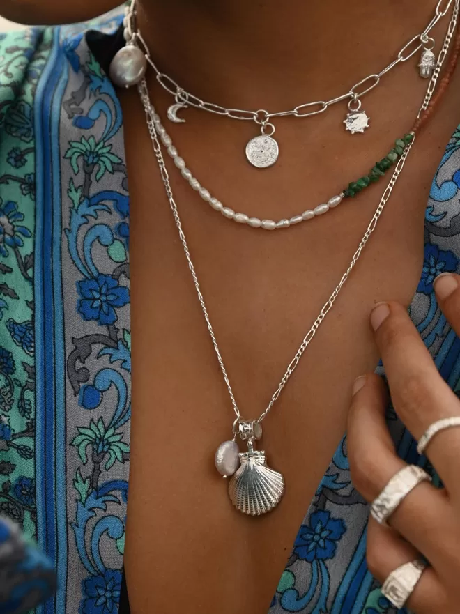 Model wearing boho shell layering necklaces with charms and pearl beaded necklace