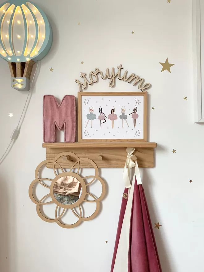 A beautiful kids space. Our Autumn's Corner Small solid wood pegrail shelf is styled up with kid's prints and wall décor. 