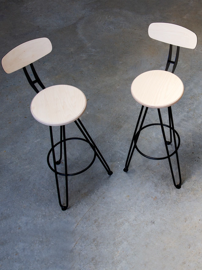 pair of hairpin leg bar chairs with birch ply seats and back rests and black hairpin legs and back support