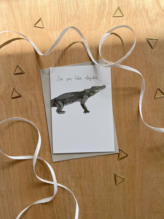 greetings card featuring an illustrated alligator and the phrase “see you later alligator”