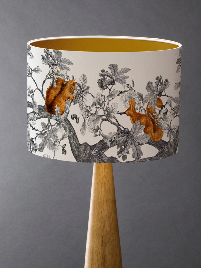 Drum Lampshade featuring Red Squirrels with a gold inner on a wooden base 