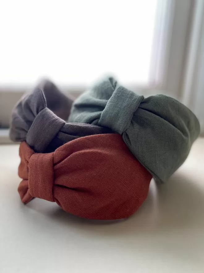Vanessa Rose Ines Headband in Sage Green seen as a stack.