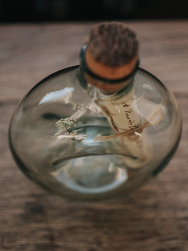 Message in a glass bottle with cork, viewed from above