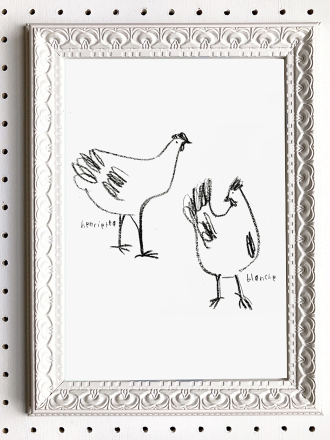black and white line drawing of chickens in white frame hanging on wall