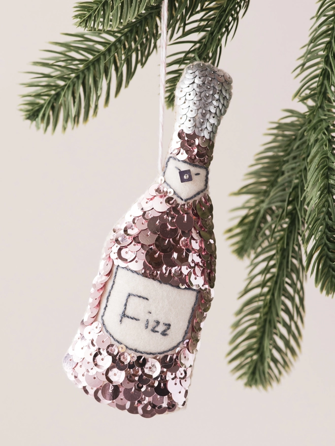 Pink Sequinned Champagne Bottle Ornament on a tree