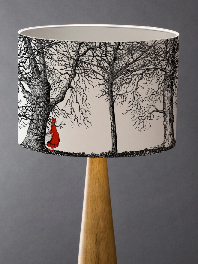 Drum Lampshade featuring Red Riding Hood with a white inner on a wooden base 