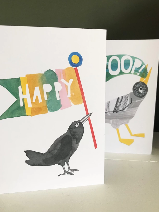 Set of three illustrated greetings cards by Esther Kent showing colourful lettering and stylised birds. The front card that reads 'HAPPY' 